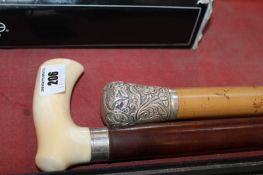 A silver metal capped gentleman`s cane and a bare handled example (2)
