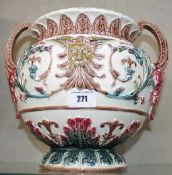 A Continental majolica two-handled jardiniere moulded in relief with masks and trailing foliage,