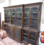 A late Victorian oak breakfront library bookcase, the moulded cornice above glazed doors and a