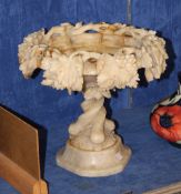 A carved alabaster tazza decorated with fruiting vines; 29cm high