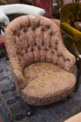 A Victorian button back armchair on cabriole legs