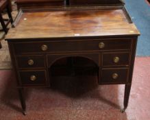 A 19th century mahogany kneehole desk with pierced brass gallery and five drawers 76cm high, 94cm