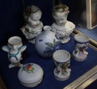 A collection of continental porcelain including two busts of children, two urn shaped Dresden vases