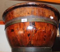 A large brass banded wooden bowl; 31.5cm x 54cm diameter