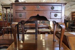 A George III oak low boy with three drawers on cabriole legs, 69cm high, 76cm wide Best Bid