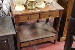 A 19th Century mahogany two tier side table with two short and a long frieze drawer on ring turned