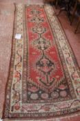 A Middle Eastern red ground runner 325cm length  Best Bid