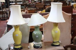 A pair of yellow ceramic vase table lamps, together with a further example (sold as parts) Best Bid