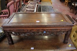An Oriental carved hardwood low table 76cm wide