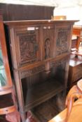 A German style ""Augsburg"" style cabinet with two cupboards flanking carved soldier with two