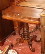 A Regency mahogany tea table with canted angles to the top on turned column and scroll carved feet