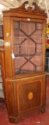 An Edwardian mahogany and satinwood decorated corner cabinet, with swan neck pediment above