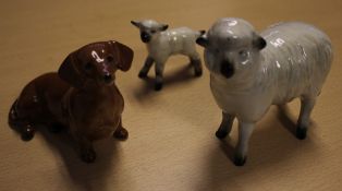 A Beswick model of a dachshund, another of a sheep and a lamb (3) Best Bid