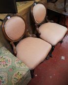 A pair of Victorian walnut balloon back chairs