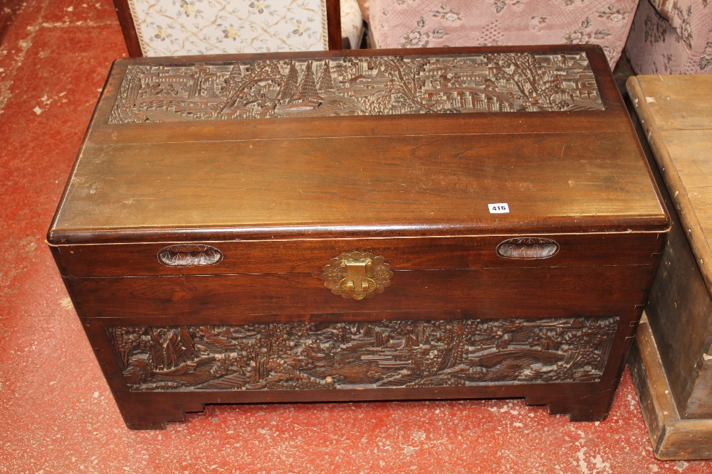 A carved camphorwood chest 101cm wide