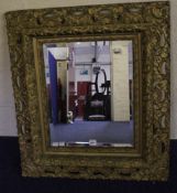 A gilt painted wall mirror with a bevelled plate 80cm high, 70cm wide
