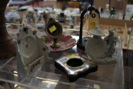 A small quantity of watch stands including three ceramic examples, a Birmingham silver hallmarked