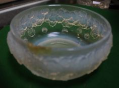 A Lalique bowl with moulded floral decoration, stamped `R.Lalique France`; 15cm in diameter (a/f),