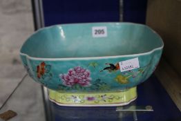 A Chinese Famille Rose square bowl of turquoise ground on a yellow base with flowers; 10cm high
