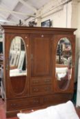 An Edwardian mahogany and inlaid triple section wardrobe 206cm high, 183cm wide