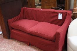 An Edwardian upholstered sofa, two feather cushions and later upholstered cover 174cm length