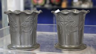 A pair of Tudric pewter small waisted vases by Liberty & Co., cast with stylised flowers, marked