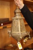 An Eastern pierced brass lamp