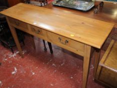 A Georgian style pine side table with three drawers 90cm high, 140cm wide