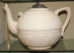 A large 19th Century white ground teapot with pewter lid; 22cm high