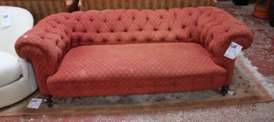 A late Victorian red upholstered chesterfield sofa.204cm length
