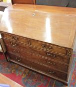A George III mahogany bureau with a satinwood and inlaid interior, two short and three long