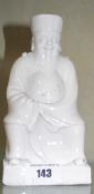 A blanc de chine model of a seated Chinese deity; 16cm high