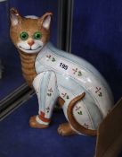 A Galle style polychrome painted ceramic cat with green glass eyes; 32cm high