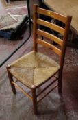 A set of four pine ladder back chairs