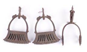 A Pair of Cast Iron Mexican Stirrups with pierced decoration at the foot, together with a Mexican