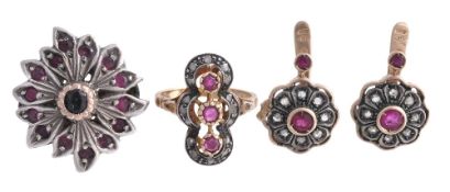 A ruby and diamond ring, the panel set with three circular cut rubies within... A ruby and diamond