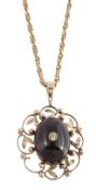 A garnet and diamond pendant, the oval cabochon garnet set with a central... A garnet and diamond