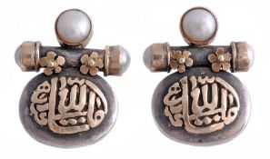 A pair of cultured pearl earrings, the polished panel with applied Arabic... A pair of cultured