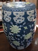 A Chinese pottery garden seat of typical barrel form with a blue ground and floral and pierced