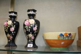 A Clarice Cliff `Bizarre` crocus bowl; 22cm in diameter, together with a pair of black ground vases