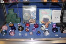 A mixed collection of glass paperweights to include Caithness examples `Acrobat`, `Quadrille` (267/