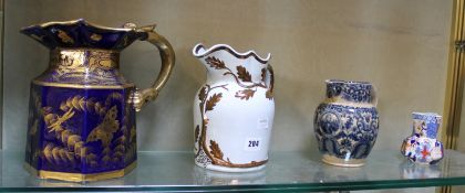 A 19th century blue and gilt octagonal jug with dragon handle (af), 25cm high, a Victorian cream