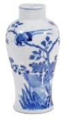 A small blue and white vase decorated with butterflies and birds perching on flowering branches,