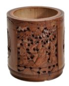 A Chinese bamboo brush pot of typical cylindrical form carved to the exterior with a central panel d