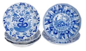 A pair of blue and white dishes, each of shallow, dodecahedronical form moulded with lappets and