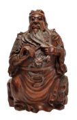 A bamboo carving of a Chinese general, possibly intended for Guandi, he is dressed in long robes