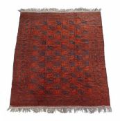 An Afghan carpet, the crimson field decorated in naby tones with guls throughout, approximately