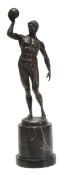 Rudolf Kuchler (Austrian, b. 1867), a bronze figure of an athlete holding a ball aloft, signed in