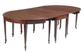 A George III mahogany extending dining table, circa 1800, with three additional leaf insertions,