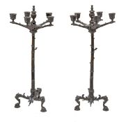 A pair of French patinated bronze five light candelabra, circa 1875, each with fluted urn finial